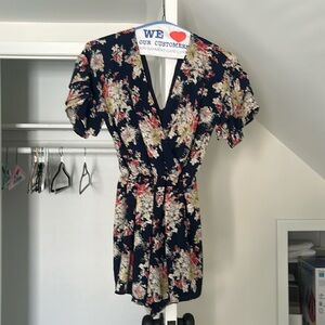 Floral navy blue romper. Deep V front and back
